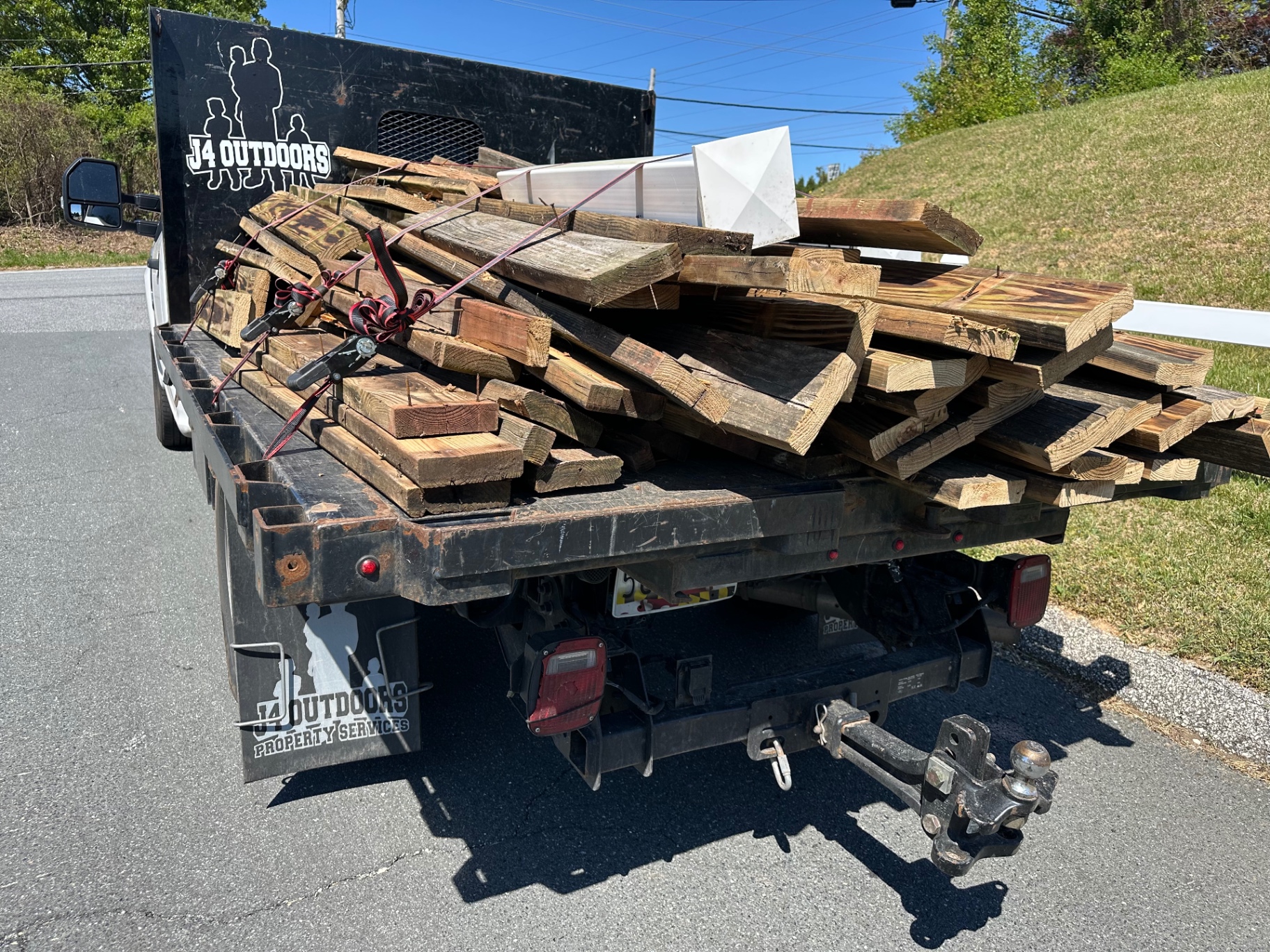 Junk Pros orange dump truck loaded with furniture and debris